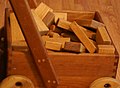 Image 6Wooden unit blocks, a type of toy block, in a wooden wagon (from List of wooden toys)