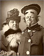 Head and shoulder shot of two men looking at the camera in pantomime costumes