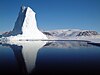 An iceberg caught in sea ice near the coast of the Arctic Baffin Bay