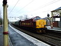 A ten-coach enthusiasts' special passing through Port Glasgow station. The rear loco carried a plate bearing "Pathfinder Tours". Such trains are not a common sight on this line. St Andrews church can be seen in the background.