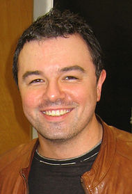 A closeup of a man's face, the man has black hair, and slight stubble on his chin and above his lip.