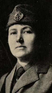 A white woman wearing a folded military-style cap