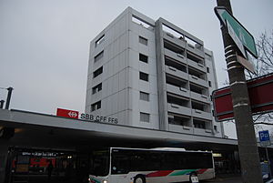 Single-story flat-roofed building with office tower