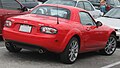 Mazda Miata Power Retractable Hard Top (PRHT) c. 2007, the hardtop constructed of polycarbonate, [13] shown raised, adding 77 lb (35 kg)[13] and providing identical cargo capacity to the soft top version.