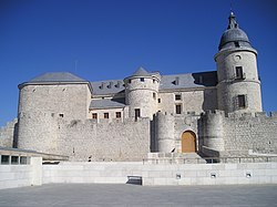 A fortress with an outer wall, a bridge to an inner wall and a tower.