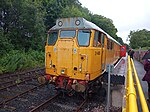 A class 31 in full yellow stationary at a Platform