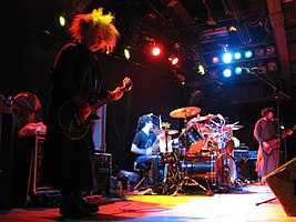 Melvins live in October 2006 — pictured (left to right) are Buzz Osborne, Coady Willis, Dale Crover (hidden behind the drums) and Jared Warren.