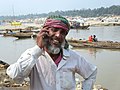 A typical marginal person in Bangladesh is talking using a mobile phone