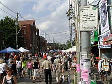 large group of people walking along street