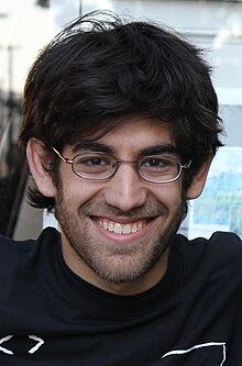 Swartz with glasses, smiling with Jason Scott (cut off from the picture from the left)