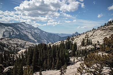 View from Olmsted Point looking south across the northern face of Clouds Rest. Half Dome is visible in the distance to the far right of Clouds Rest.