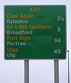 A Scottish sign using the typeface on the Isle of Skye, with placenames given in both Scots Gaelic and English, and distances shown in miles.