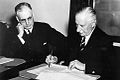 Governor-General The Earl Gowrie signing the declaration of War against Japan, with Curtin looking on.