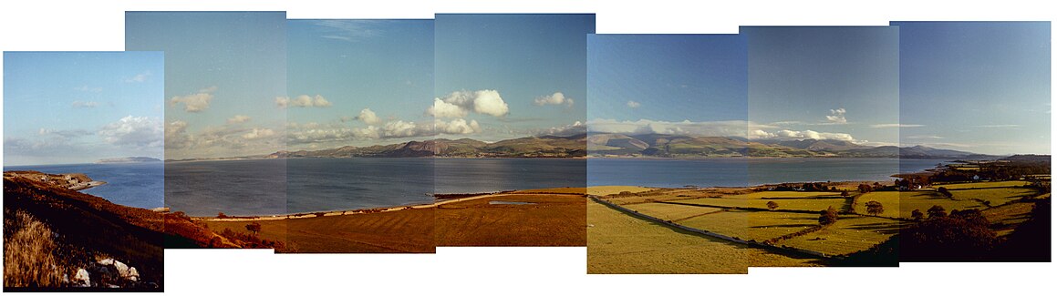 Panorama from Penmon old Deer Park across the Menai Strait with Snowdonia in the background.