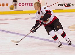 Man in hockey jersey skating on ice