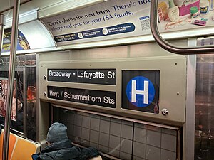 An R68 operating erroneously displays the blue H train bullet for the Rockaway shuttle.