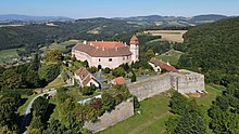 A medieval castle with a tower surrounded by a wall