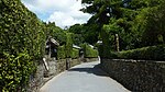 Small street lined with low stone walls.