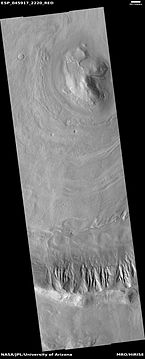 Wide view of dipping layers in Ismenius Lacus quadrangle, as seen by HiRISE under HiWish program. Gullies are also visible at the bottom of the image.