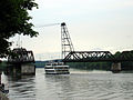 A tour boat passes though the Livingston Avenue Bridge, a railroad swing bridge over the Hudson River.