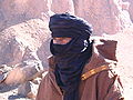 A man of the Tuareg people of North Africa wears a tagelmust or turban dyed with indigo. The indigo stains their skin blue; they were known by early visitors as "the blue men" of the desert.