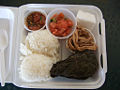 Native Hawaiian preparations and fish dishes were integrated into the plate lunch traditions. This plate lunch consists of ahi poke, lomi lomi salmon (salmon was introduced but the lomi massaging technique is native), kalua pork, pork lau lau, two scoops rice, and haupia