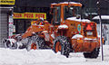 A loader clears snow in New York City during a lull in the snowfall on Sunday, February 12.