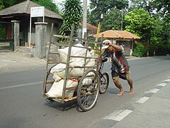 Pushing a loaded freight bike in Jakarta, Indonesia