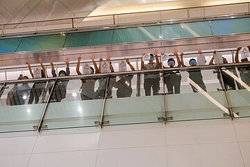 Protesters using hand signals to refer to the five demands