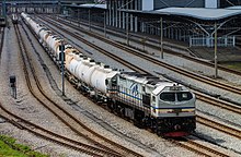 A KTMB Class 26 is resting with its cement train at Ipoh station.