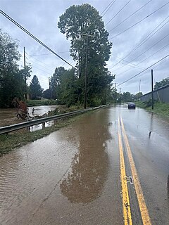 A flooded street near a swollen river in Buncombe County, North Carolina, on September 27, 2024.