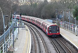 A train of 1992 stock approaching Roding Valley station on the Central Line.