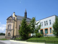 Main street in Bukowsko, Catholic Church and city bank.