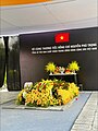 The funeral of Nguyễn Phú Trọng, displaying the Vietnamese flag with a black ribbon on the top right corner.