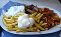 A "Taxi Teller" is a plate of fries served with currywurst, shashlik sauce, mayonnaise, gyros meat, and tzatsiki