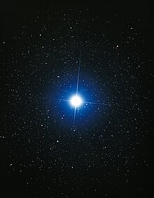 The star Sirius. It is shown as blue and is significantly larger and brighter than surrounding stars.