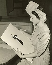 Irene Saltern holding her dress sketch from the movie So Ends the Night released in 1941