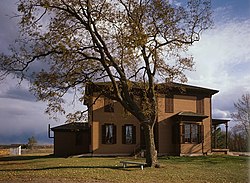 A two-story wooden house with one-story projections