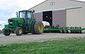 A John Deere 7800 tractor attached to a corn planter.