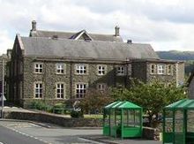 small two-storey building of flint and sandstone