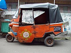 Former 2-stroke orange Bajaj in Jakarta