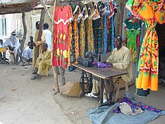 A Chadian tailor sells traditional dresses.