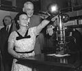 Clydia Mae Richardson, who led the effort to put the seal on display, and John Foster Dulles imprint a document during the 1955 ceremony