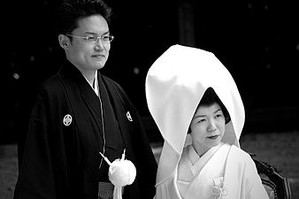 Japanese men traditionally wear a black kimono with some white decoration on their wedding day