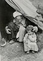 Old and young in the entrance of a tent, 1948[citation needed]