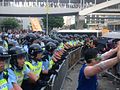 PTU officers defending a barricade.