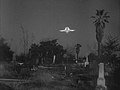 A Flying Saucer wobbles unrealistically as it descends into a San Fernando cemetery