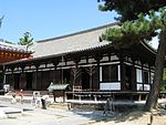 Wooden building with white walls and a slightly raised floor.