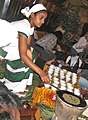 Image 31An Ethiopian woman preparing Ethiopian coffee at a traditional ceremony. She roasts, crushes, and brews the coffee on the spot. (from Culture of Africa)