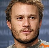 A headshot of Heath Ledger as he looks away from the camera